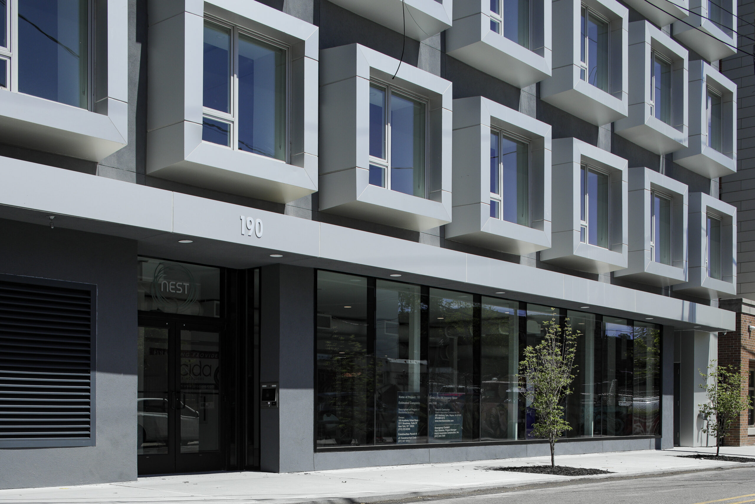 Modern building with cube-shaped windows and glass storefront.