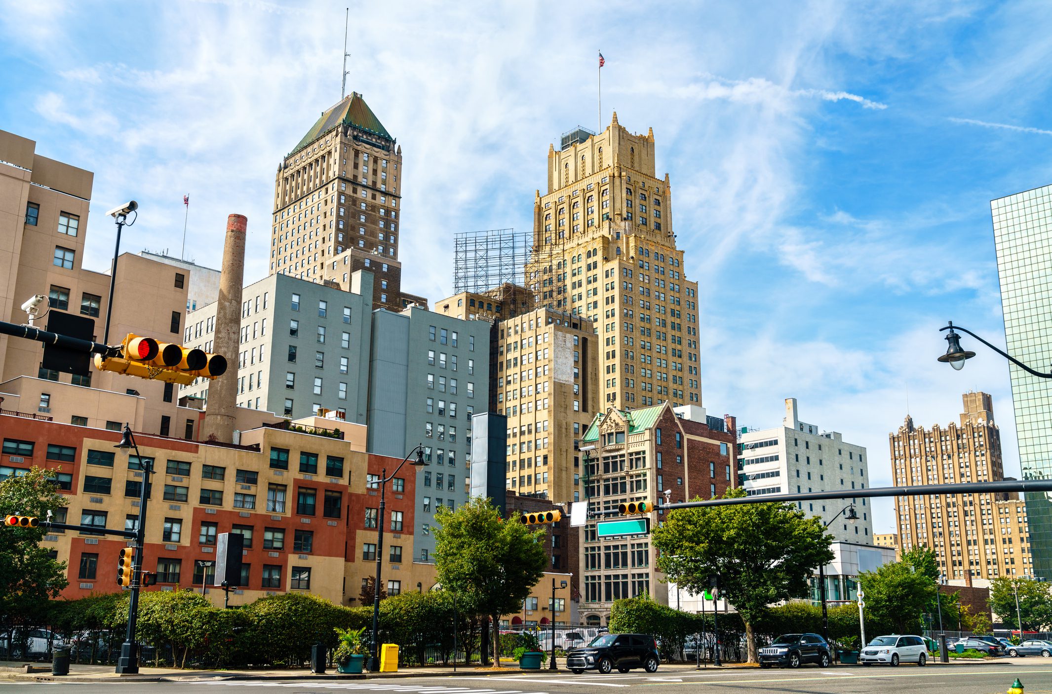 City skyline with a mix of modern and historic buildings under a blue sky.